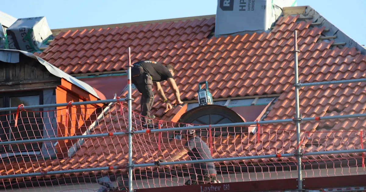 A man on a roof working on a roof