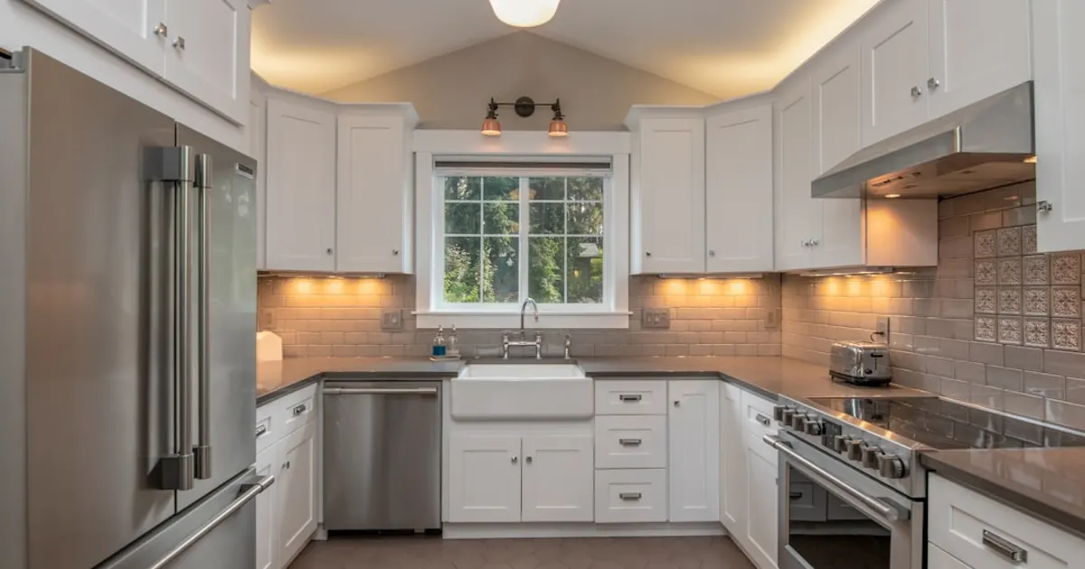 White wooden kitchen cabinet with white pendant lamp