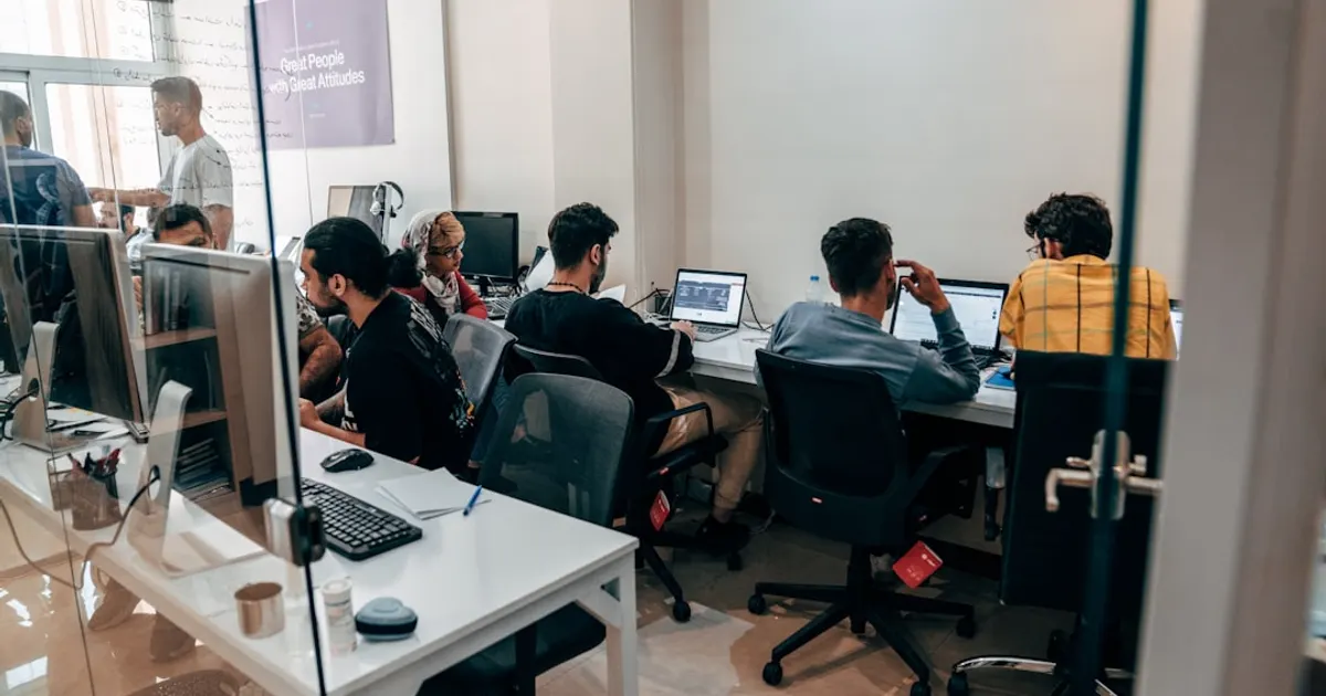 A group of people sitting at computers