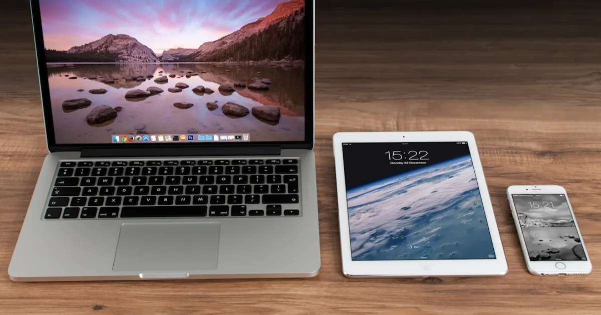 MacBook Pro beside iPad and iPhone turned on