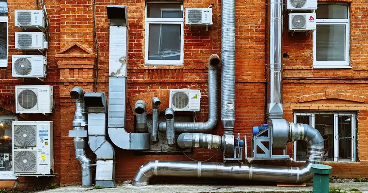 A building with a bunch of pipes on the side of it