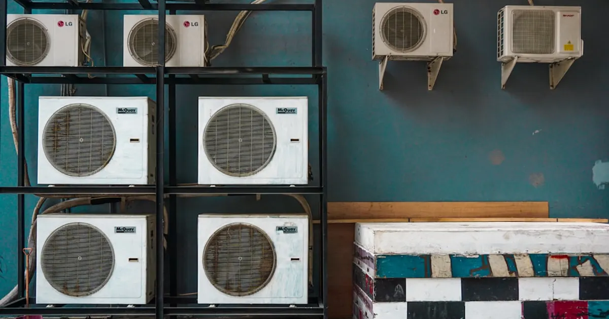 White and black box fan on brown wooden shelf