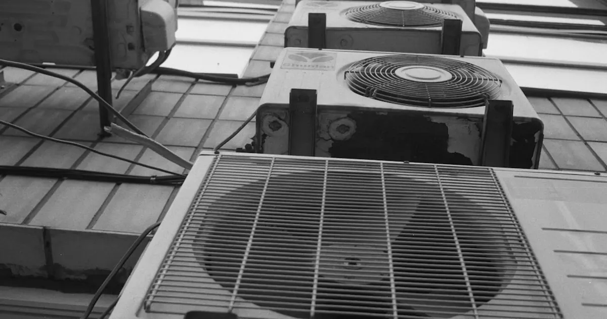 A row of air conditioners sitting on top of a tiled floor