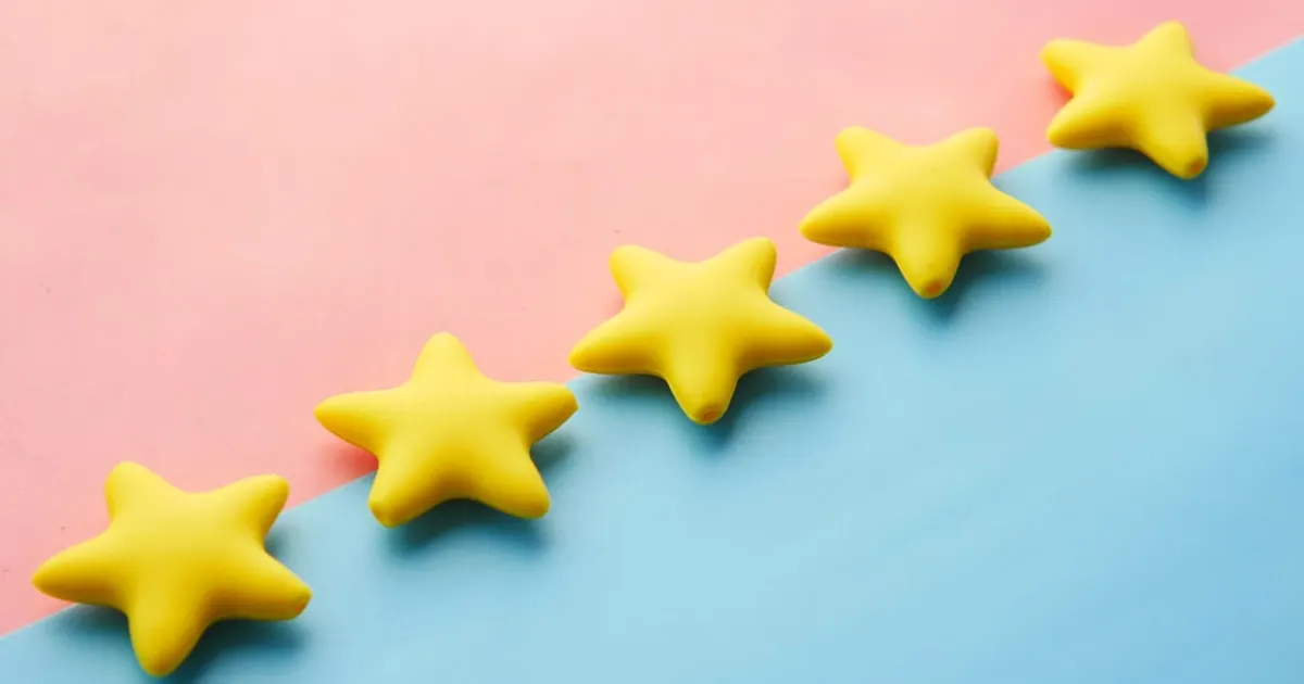 A row of yellow stars sitting on top of a blue and pink surface