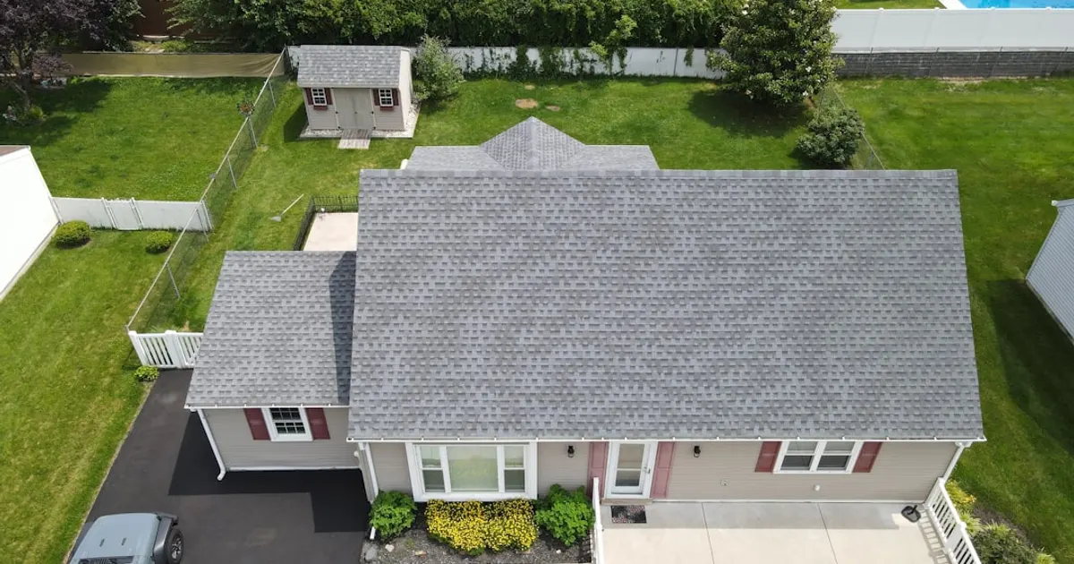 Aerial view of a suburban house with a grey roof